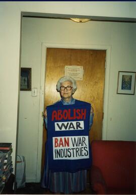 Interior, Lea with a banner 'Abolish war; Ban on war industries'.