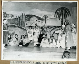 Workmen's Circle Abraham Reisen Schools, central school, student performance, scene from "Shulamit." Interior group portrait of students in costume on stage.