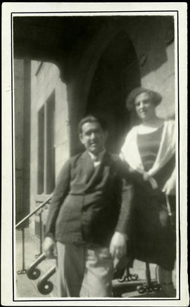 Maurice and Mary Zbriger posed on steps, against building railing