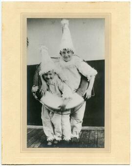 Portrait of two children in clown outfits, with a nautical theme