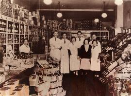 Interior, grocery store, Steinberg store. Group portrait, employees, Ida Steinberg (behind cash).
