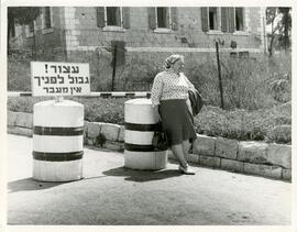 Exterior shot of a woman at the Mandelbaum Gate
