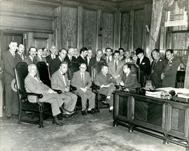 Office scene featuring Itzik Feffer, Solomon Mikhoels, and large group
